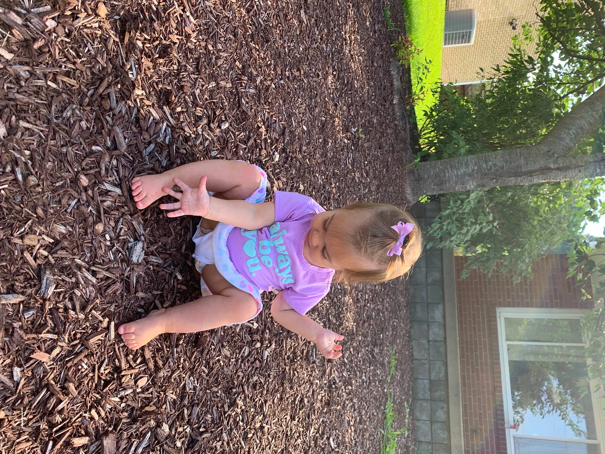 Amelia is registered to the contest to win money with this photo: city, fun, garden, grass, happy, human_leg, landscape, leisure, magenta, people_in_nature, person, picture_frame, plant, play, recreation, sandal, soil, t_shirt, thigh, toddler