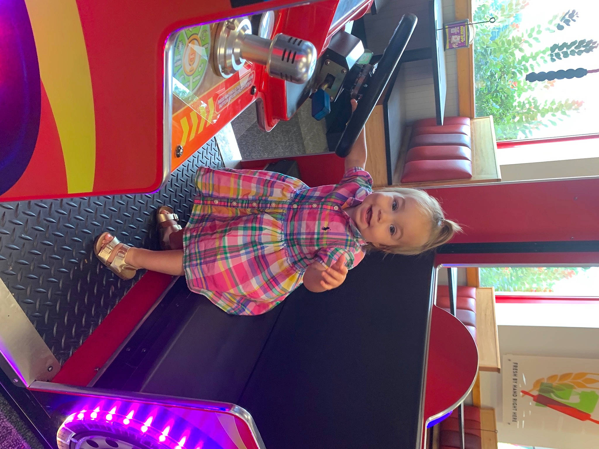 Amelia is registered to the contest to win money with this photo: automotive_lighting, bumper, child, entertainment, fun, house, interior_design, leisure, luxury_vehicle, magenta, motor_vehicle, pattern, person, plaid, play, recreation, room, tartan, toddler, toy