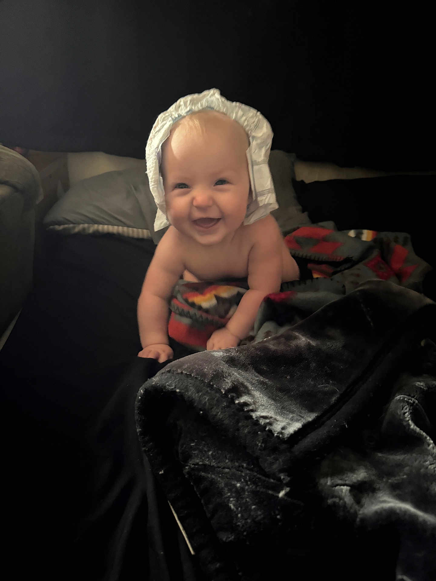 Maelynn joined the competition — help win amazing prizes! baby, bed, blanket, child, comfort, crawling, cute, expression, face, happy, headwear, indoors, infant, person, playful, portrait, smiling, soft_texture, warm, young