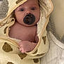 baby, infant, pacifier, hooded_towel, bear_pattern, blanket, cute, child, skin, hand, face, eyes, soft, plush, indoor, resting, cozy, newborn, wrapped, towel