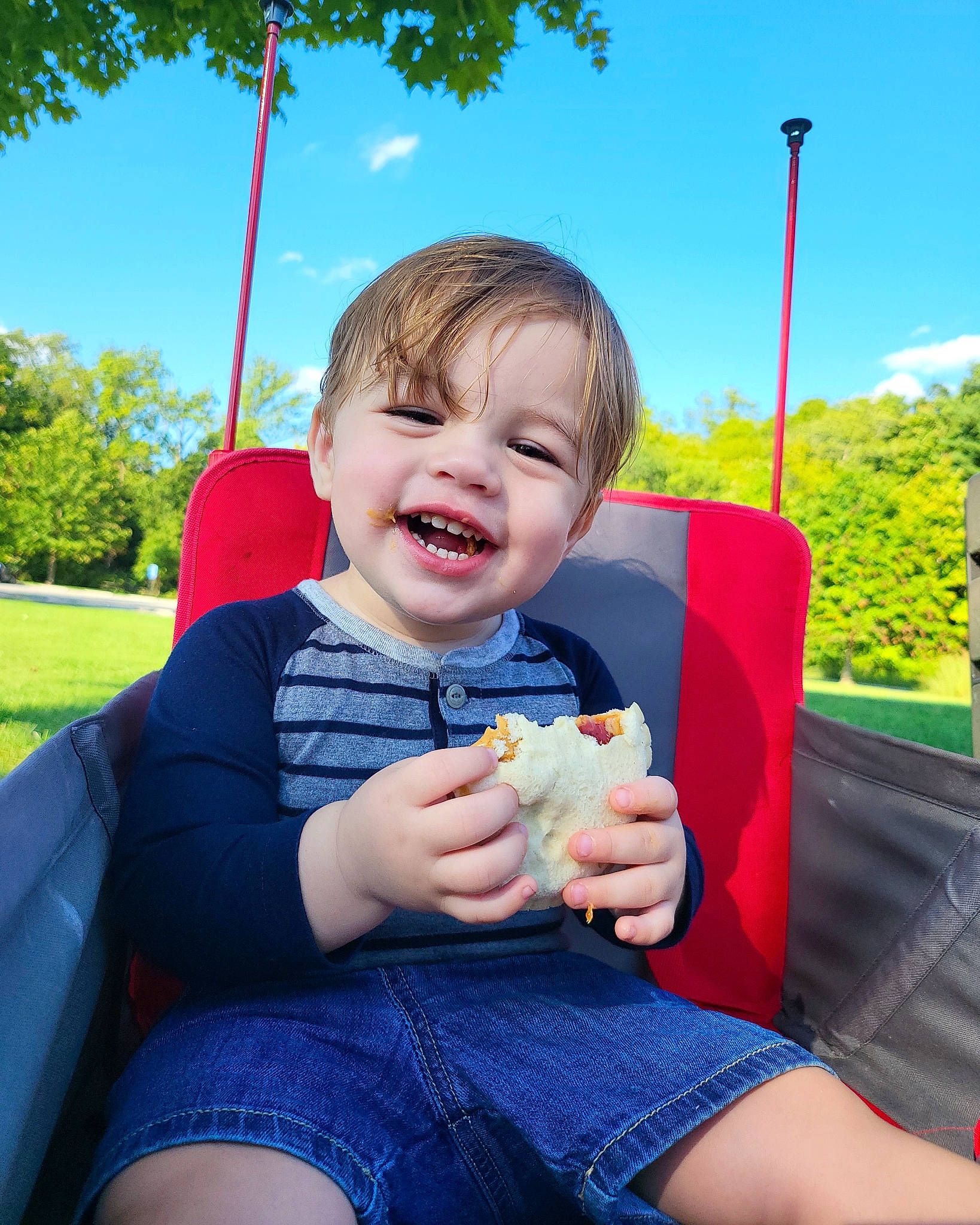 Leonidas is registered to the contest to win money with this photo: clothing, cool, electric_blue, eye, finger, fun, gesture, grass, hand, happy, leisure, person, plant, skin, sky, smile, summer, swing, thumb, toddler