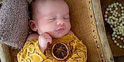 Maddie participe au concours pour gagner de l'argent avec cette photo : baby, beads, child, closeup, cozy, crib, dried_orange, fabric, hand, jewelry, lace, newborn, peaceful, pillow, portrait, skin, sleeping, texture, wooden_frame, yellow_clothing