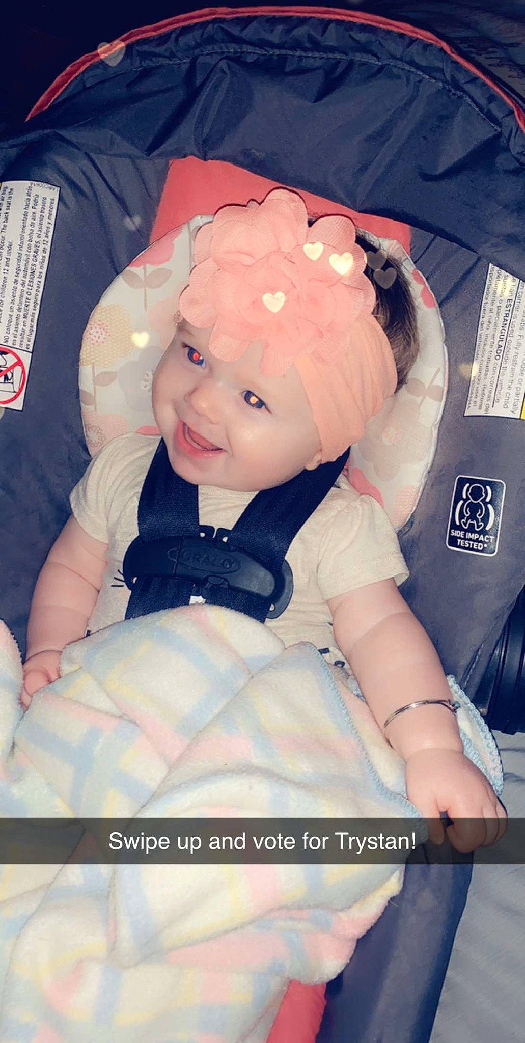 Trystan is registered to the contest to win money with this photo: arm, baby, car_seat, cheek, child, headwear, person, toddler