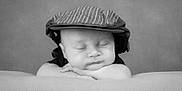 Aiden is registered to the contest to win money with this photo: baby, sleeping, hat, cap, black_and_white, portrait, child, cute, peaceful, soft, blanket, resting, infant, face, headwear, closeup, calm, toddler, hands, monochrome