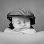 baby, sleeping, hat, cap, black_and_white, portrait, child, cute, peaceful, soft, blanket, resting, infant, face, headwear, closeup, calm, toddler, hands, monochrome