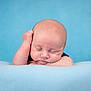 Aiden joined the competition — help win amazing prizes! baby, sleeping, peaceful, blue_background, blanket, infant, soft_texture, cute, newborn, portrait, resting, head, face, skin, hand, calm, child, indoors, closeup, young