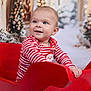 baby, blue_eyes, celebration, child, christmas_theme, cute, decorations, festive, festivity, happy, holiday_lights, indoor, portrait, red_sleigh, seasonal, smiling, snow, striped_clothing, toddler, winter