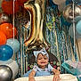 Addisynn is registered to the contest to win money with this photo: baby, high_chair, balloon, birthday, party, celebration, headband, blue_dress, smiling, child, decorations, number_one_balloon, streamers, indoor, festive, happy, toddler, cosco, colorful, photography