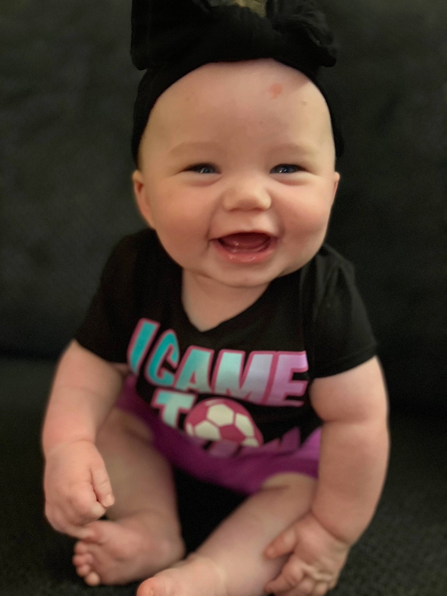 Annalise is registered to the contest to win money with this photo: arm, baby, baby_toddler_clothing, cap, cheek, eye, finger, hand, happy, hat, headwear, human_body, joy, lip, mouth, neck, nose, person, pink, skin