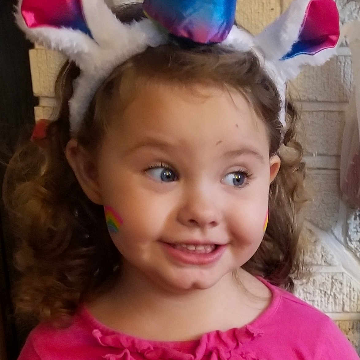 Jillian is registered to the contest to win money with this photo: child, ear, fashion_accessory, hair_accessory, head, headband, headgear, joy, organ, party_hat, person, pink, toddler