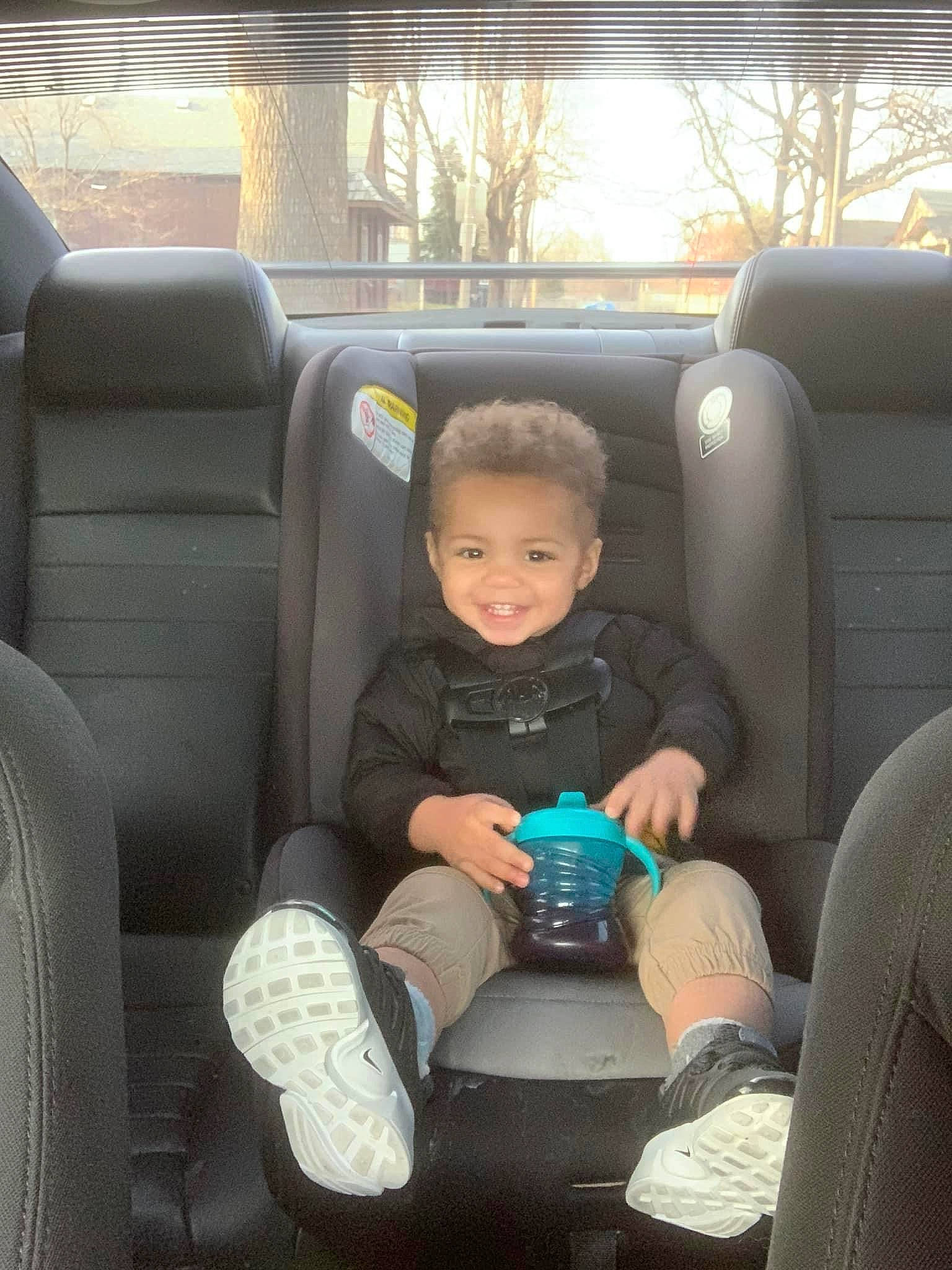 Steffon is registered to the contest to win money with this photo: auto_part, automotive_design, automotive_exterior, car, car_seat, car_seat_cover, comfort, family_car, head_restraint, joy, lap, leg, mode_of_transport, motor_vehicle, person, personal_luxury_car, seat_belt, smile, toddler, vehicle