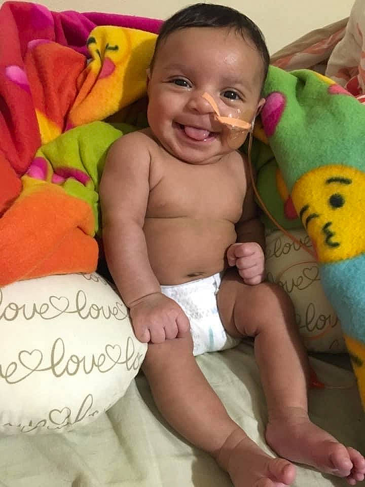 Amarianna is registered to the contest to win money with this photo: arm, baby, baby_toddler_clothing, cheek, chest, comfort, eye, face, finger, happy, head, iris, joy, mouth, person, pink, skin, smile, stomach, textile