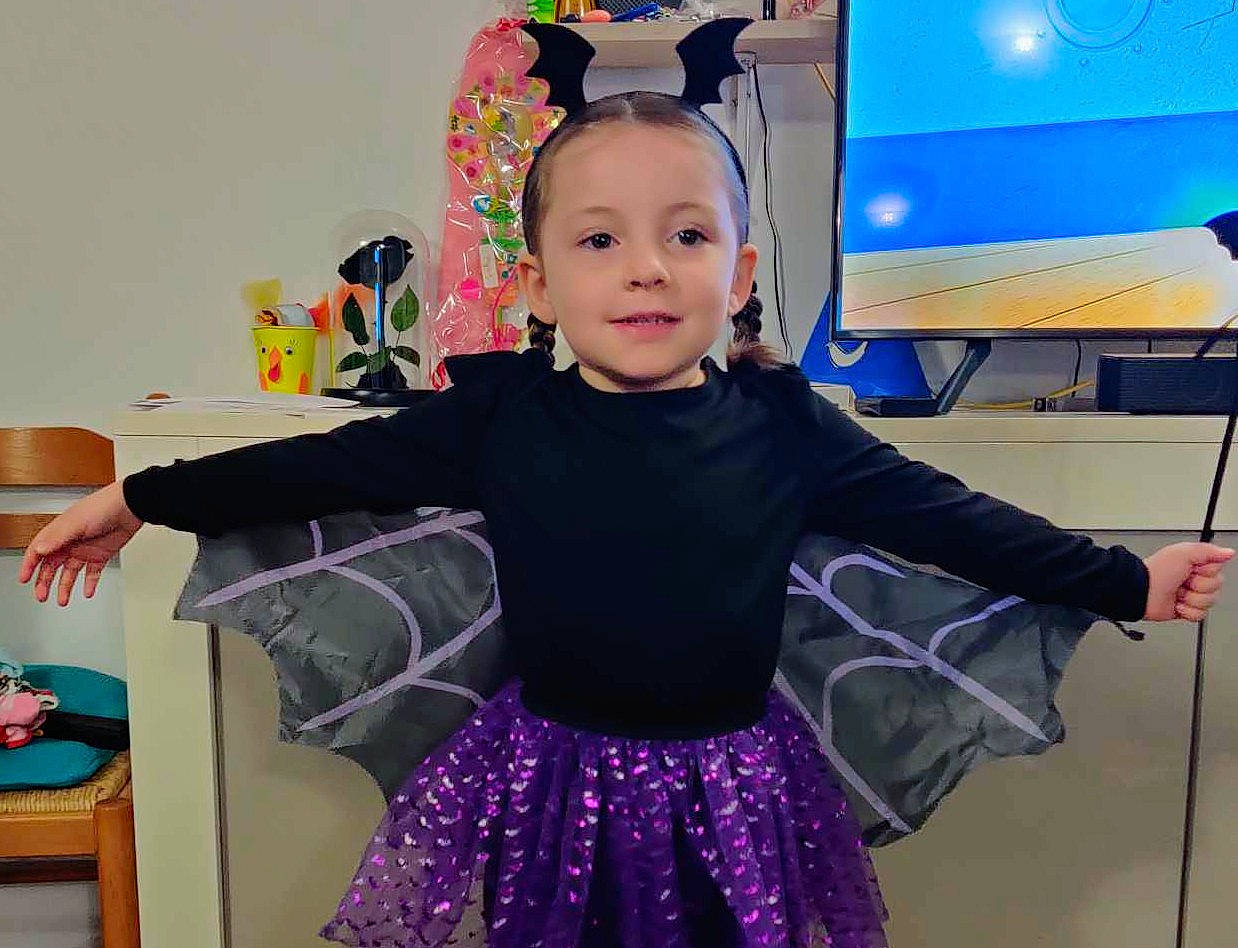 Sophia participe au concours pour gagner de l'argent avec cette photo : baby, baby_toddler_clothing, child, costume, display_device, entertainment, event, fun, happy, iris, joy, magenta, person, pink, purple, sleeve, smile, standing, t_shirt, television