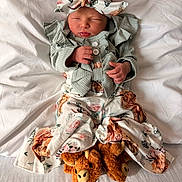 Lakelynn joined the competition — help win amazing prizes! baby, newborn, infant, headband, bow, swaddle, blanket, bed, sleeping, hands, outfit, buttons, plush_toy, slippers, animal_slippers, floral_print, ruffles, cozy, portrait, cute