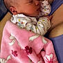baby, newborn, sleeping, blanket, pink_blanket, floral_print, onesie, infant, cuddling, parent, chest, cozy, close_up, portrait, head, ear, hand, skin, fabric, bed