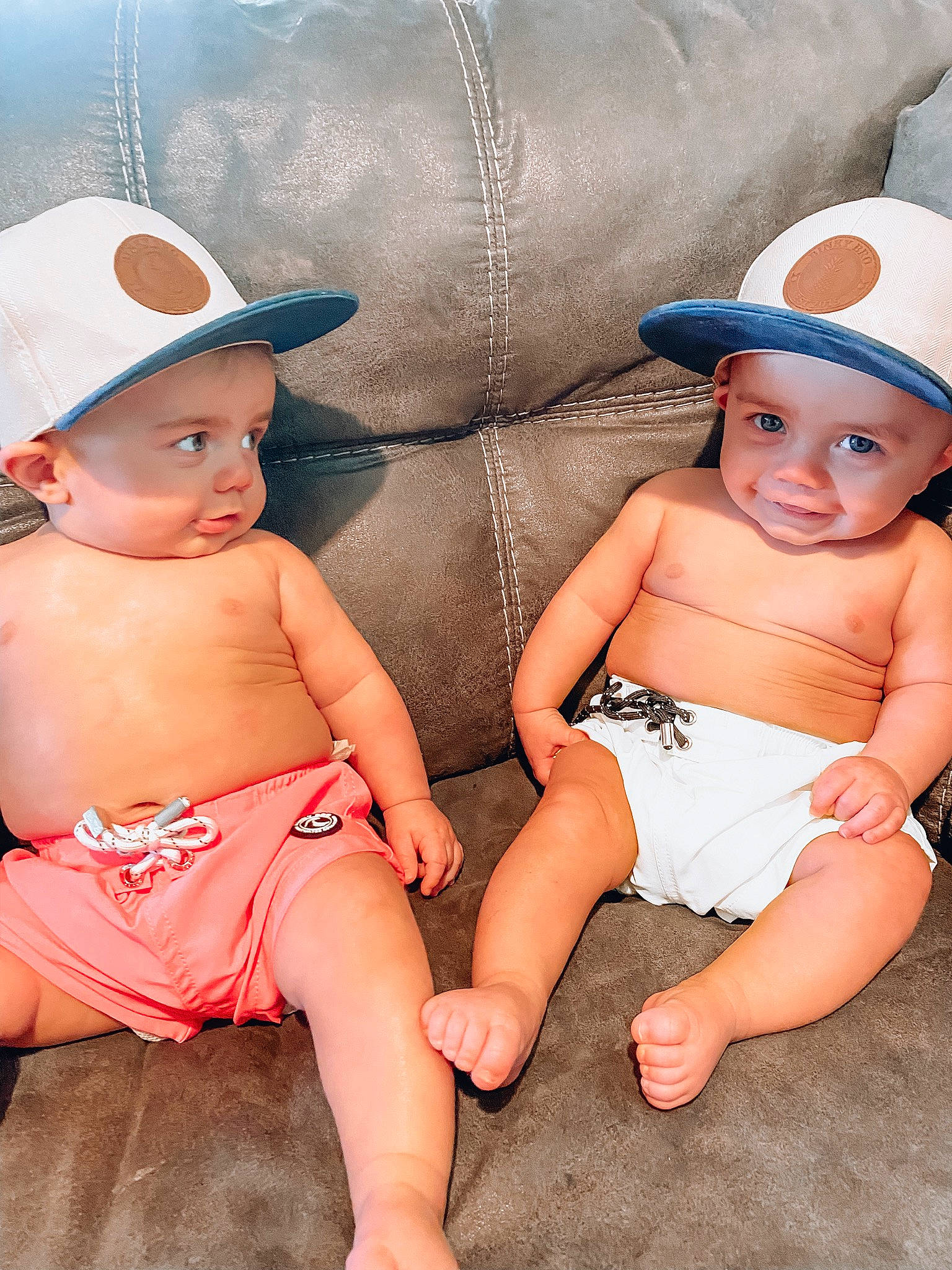 Archer And Atticus joined the competition — help win amazing prizes! baby, baby_toddler_clothing, blue, cap, child, comfort, finger, happy, hat, headgear, headwear, human_body, human_leg, leg, mouth, person, pink, skin, sun_hat, thigh