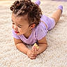 Aylanis joined the competition — help win amazing prizes! toddler, child, baby, curly_hair, smiling, eating, bread, snack, purple_clothing, romper, earrings, lying_down, carpet, indoor, portrait, happy, face, hands, soft_lighting, home