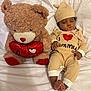 baby, sleeping, pacifier, hat, teddy_bear, stuffed_animal, heart, bed, blanket, cozy, infant, cute, soft, plush, child, resting, comfortable, clothing, lying_down, adorable