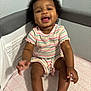 baby, child, smiling, curly_hair, striped_clothing, playpen, happy, infant, sitting, cute, indoors, person, young_child, toddler, skin, face, legs, arms, joy, home