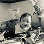 Mateo joined the competition — help win amazing prizes! baby, smiling, blanket, bib, countertop, flower, vase, lamp, indoor, happy, infant, kitchen, person, portrait, cozy, black_and_white, home, cute, cheerful, toddler
