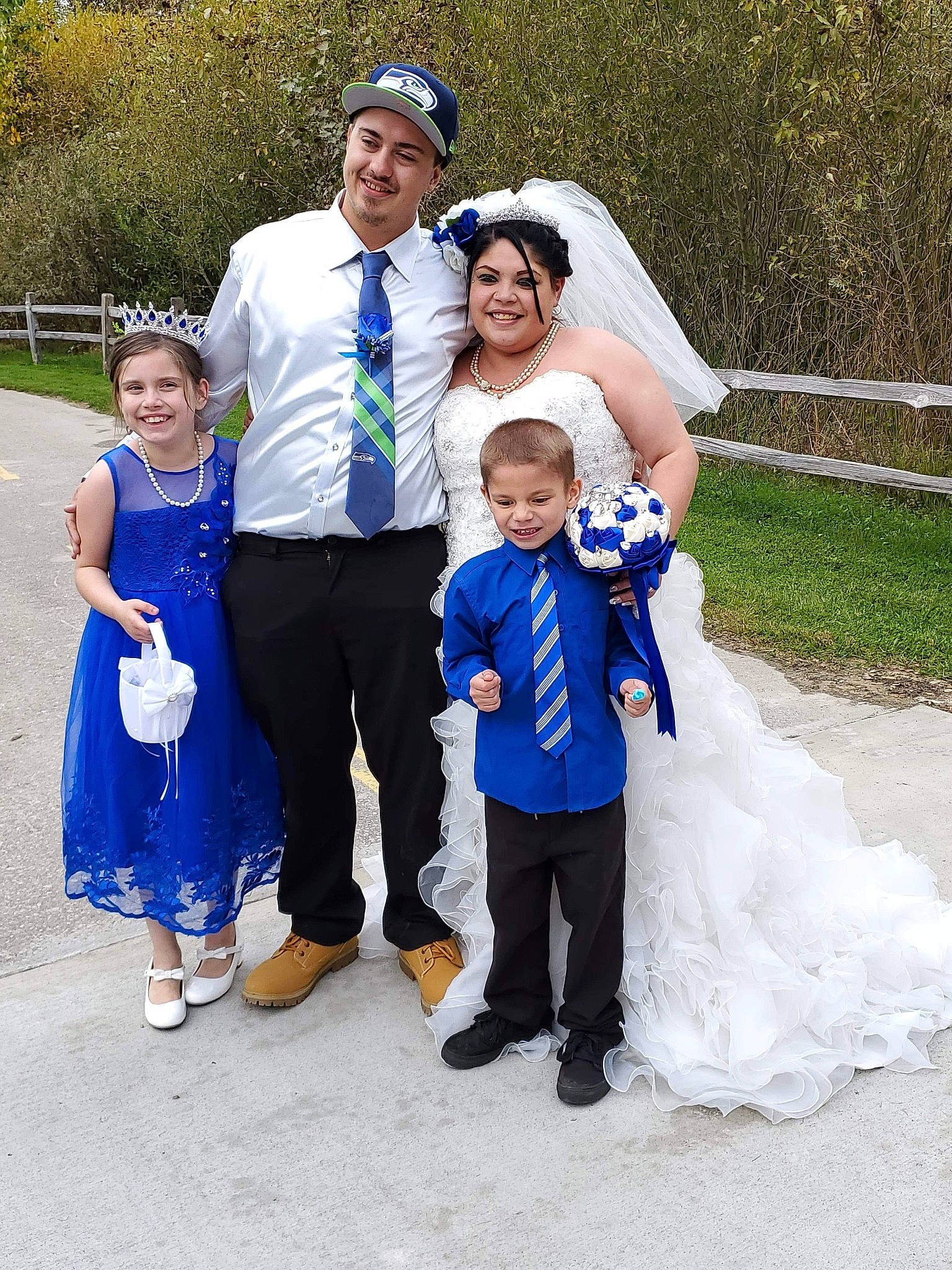 Myah joined the competition — help win amazing prizes! blue, bridal_clothing, bride, ceremony, child, dress, event, family, formal_wear, gown, happy, headwear, joy, marriage, people, person, photograph, plant, smile, suit