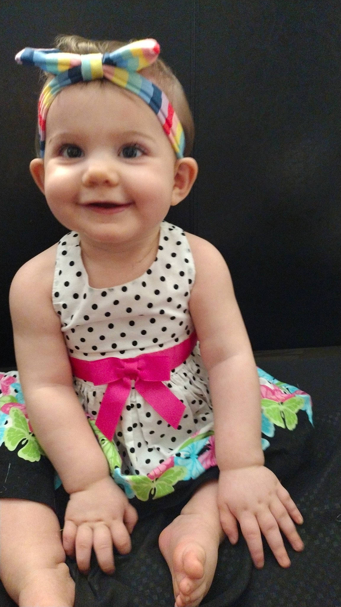 Dakota is registered to the contest to win money with this photo: baby, baby_toddler_clothing, beauty, child, dress, face, facial_expression, finger, fun, hand, happy, head, headwear, joy, pattern, person, pink, sitting, skin, sleeve