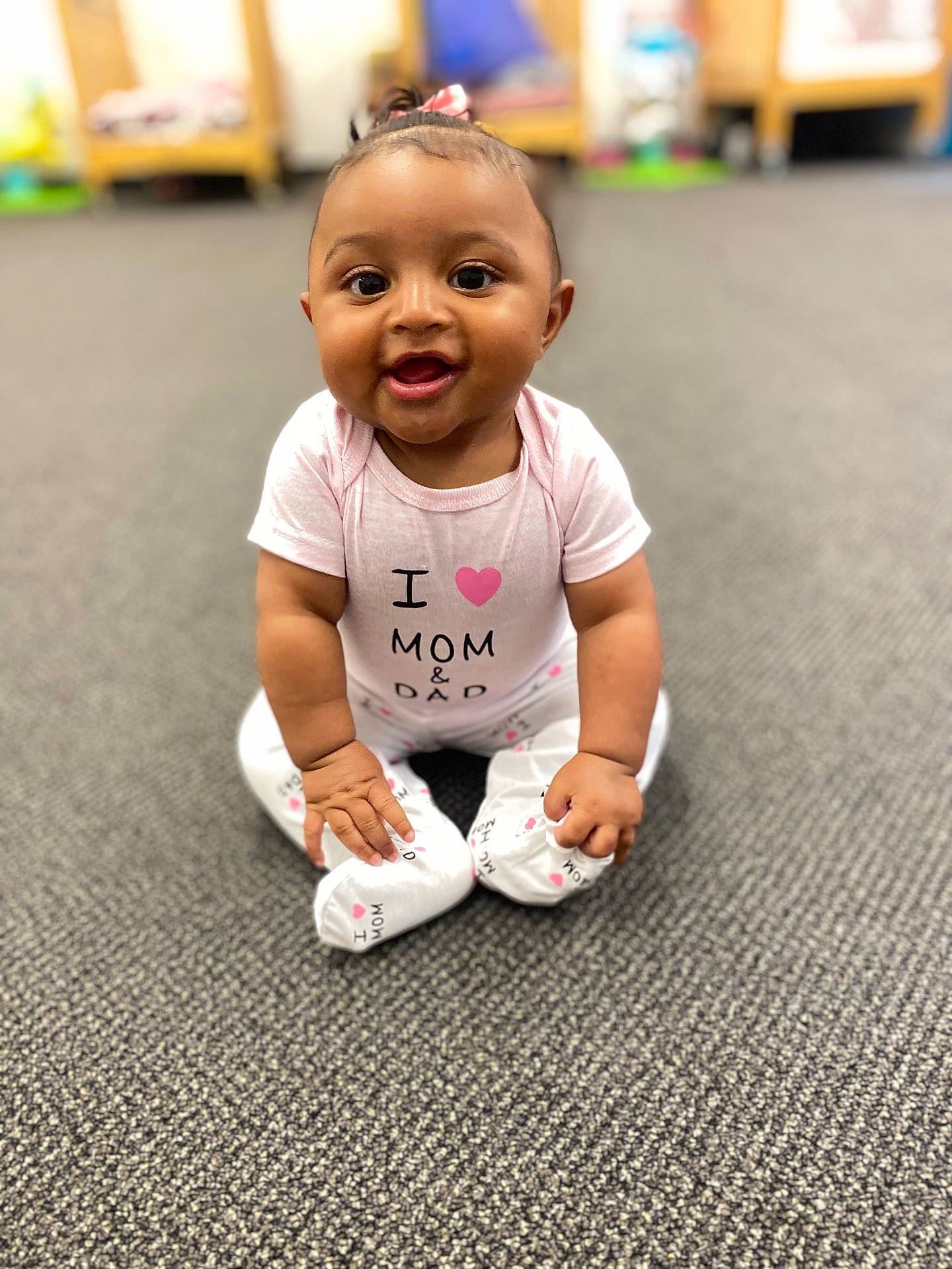 Zanayah is registered to the contest to win money with this photo: baby, ball, clothing, crawling, diaper, face, football, footwear, happy, head, pants, person, photography, portrait, shoe, sitting, soccer, soccerball, sport, t_shirt