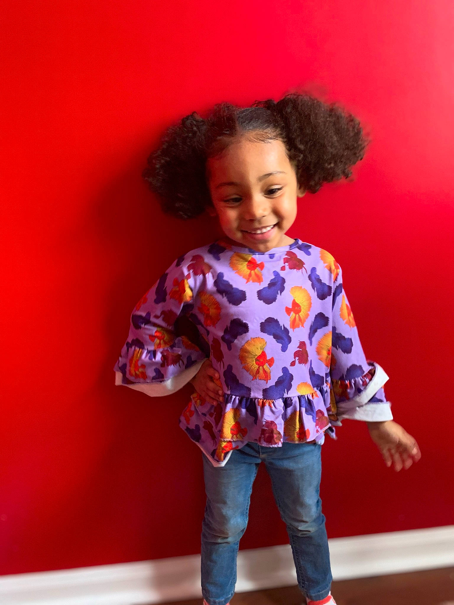 Malaysia is registered to the contest to win money with this photo: baby_toddler_clothing, chin, clothing, face, fashion_design, hair, happy, head, jeans, joy, magenta, nose, orange, person, pink, purple, skin, sleeve, smile, standing