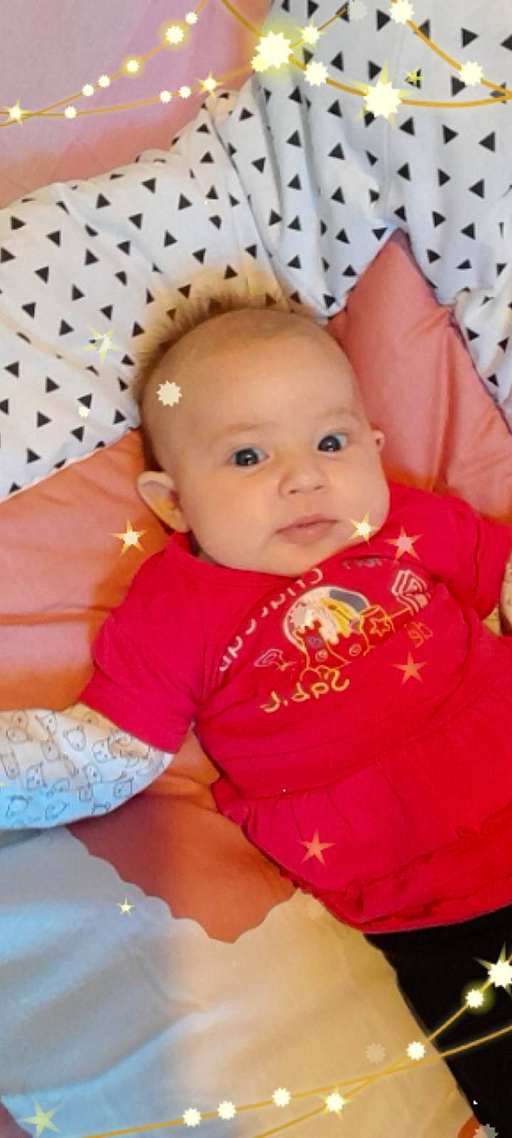 Eleana participe au concours pour gagner de l'argent avec cette photo : baby, baby_toddler_clothing, cheek, child, chin, comfort, eye, eyebrow, happy, head, iris, linens, lip, nose, pattern, person, pink, skin, sleeve, smile