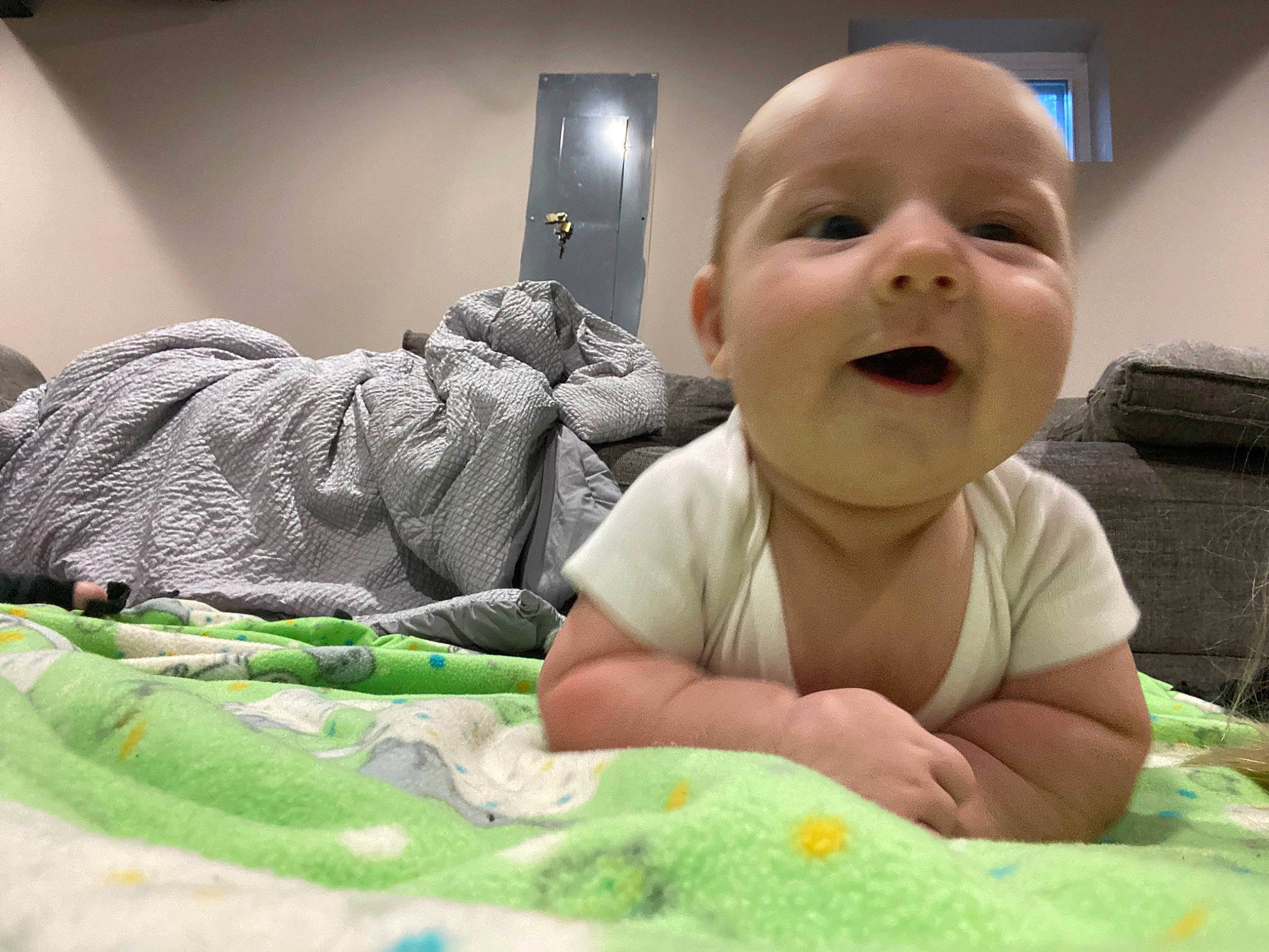 Maxton is registered to the contest to win money with this photo: baby, baby_toddler_clothing, bed, cheek, child, comfort, finger, fun, grass, green, happy, linens, mouth, nose, person, room, skin, smile, thumb, toddler