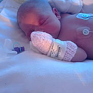 Gypsi-Ami is registered to the contest to win money with this photo: newborn, baby, hospital, incubator, sleeping, medical, sensor, mitten, knitted, blanket, bed, patient, healthcare, infant, child, rest, cute, peaceful, pediatric, monitor