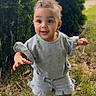 toddler, child, grass, outdoor, greenery, curly_hair, blue_outfit, sandals, cute, standing, smiling, young_child, nature, daylight, portrait, person, small_child, playful, summer_clothing, happy