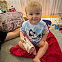 Riley joined the competition — help win amazing prizes! toddler, child, smiling, sitting, couch, blanket, purse, toy, indoor, person, clothing, mickey_mouse, face, hand, foot, hair, home, furniture, curtain, relaxed