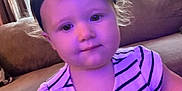 Riley joined the competition — help win amazing prizes! toddler, child, indoor, striped_dress, headband, couch, curtains, window, face, person, young_child, purple_tint, smile, hair, baby, clothing, furniture, portrait, sitting, cute