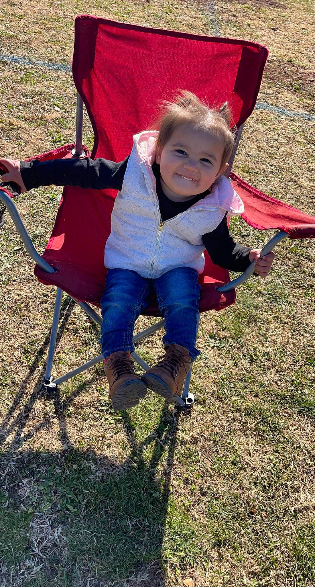 Aleena is registered to the contest to win money with this photo: baby_toddler_clothing, chair, child, electric_blue, folding_chair, fun, grass, happy, hoodie, joy, leisure, people_in_nature, person, plant, play, recreation, sitting, smile, soil, toddler