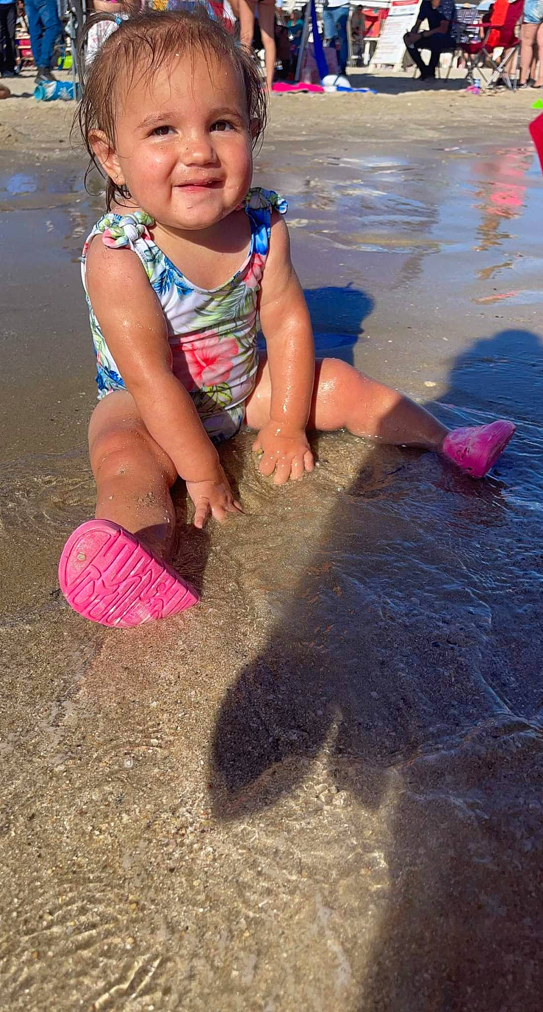 Aleena is registered to the contest to win money with this photo: baby_toddler_clothing, barefoot, child, foot, fun, happy, joy, leg, leisure, mouth, people_in_nature, people_on_beach, person, pink, play, recreation, sand, skin, smile, summer