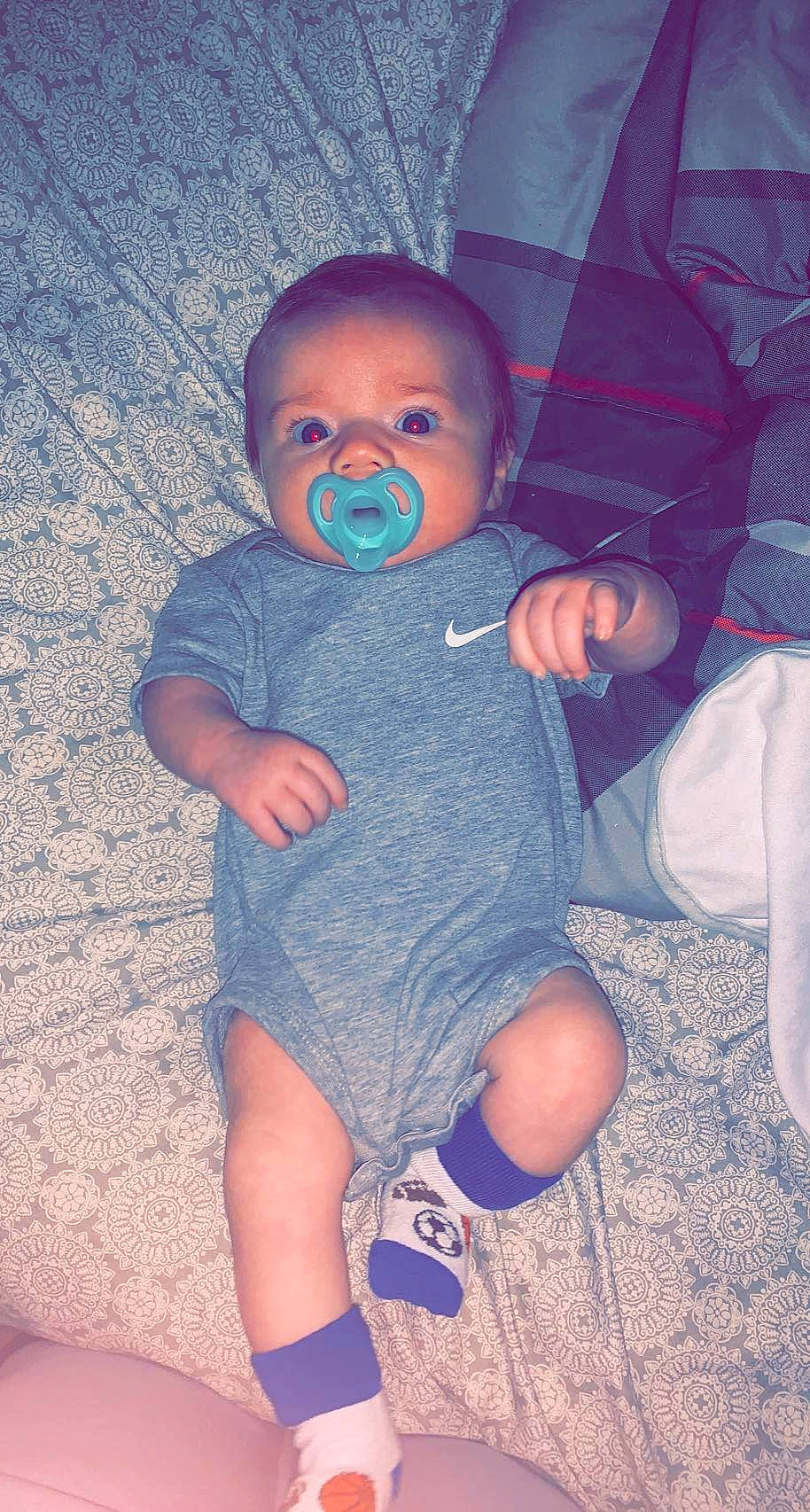 Korbyn is registered to the contest to win money with this photo: baby, baby_toddler_clothing, blue, comfort, eye, finger, head, headgear, human, iris, joint, leg, lip, mouth, neck, person, purple, skin, sleeve, thigh