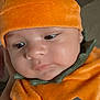 baby, infant, pumpkin_costume, orange, hat, cute, portrait, child, costume, holiday, halloween, face, closeup, soft_lighting, indoor, expression, person, seasonal, festive, apparel