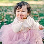 toddler, child, smiling, curly_hair, pink_tutu, cream_sweater, grass, autumn_leaves, outdoor, nature, cute, happy, baby, portrait, sitting, playful, daylight, soft_light, fall, young_child