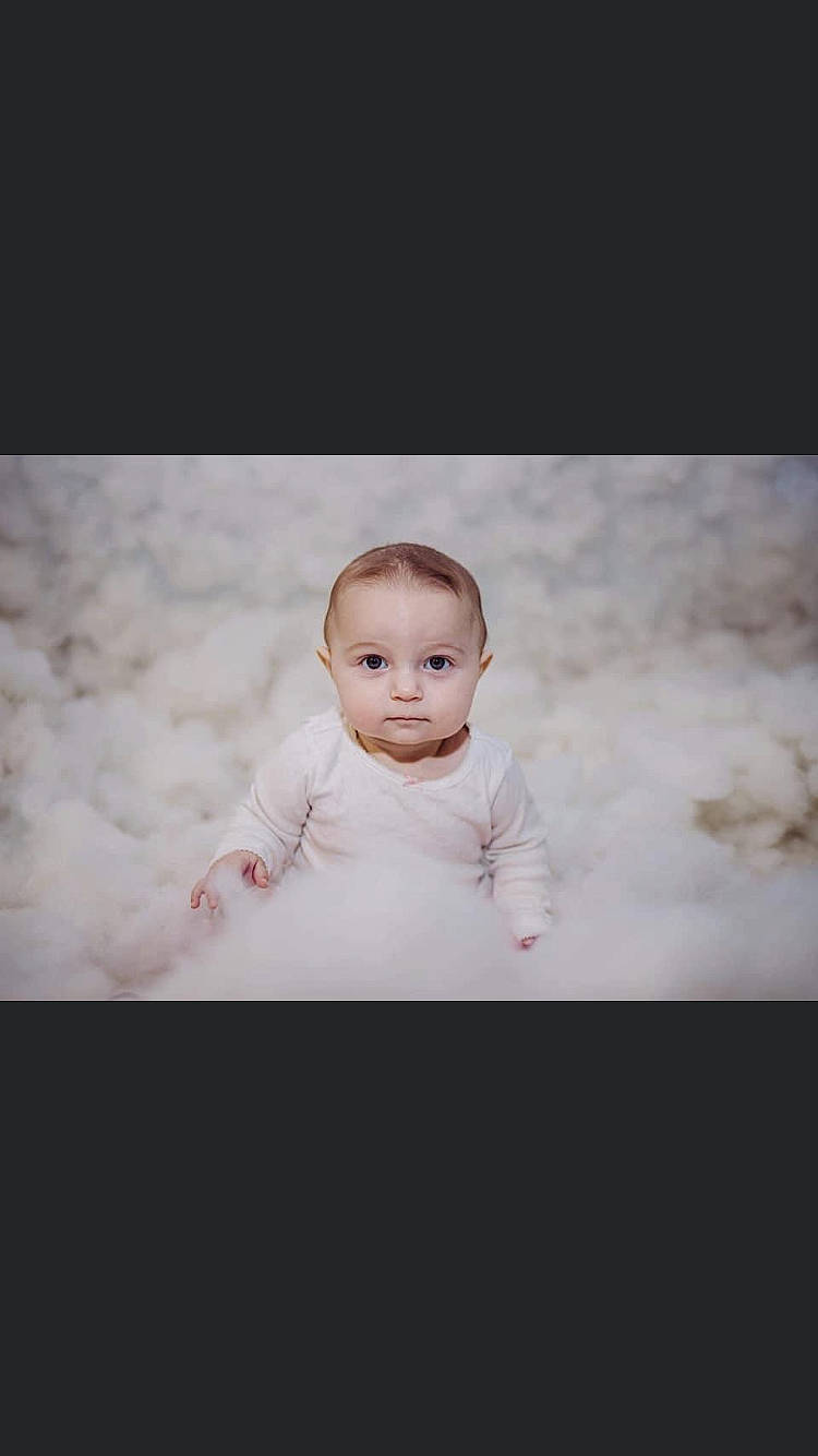 Bellamy Eudora is registered to the contest to win money with this photo: baby, baby_toddler_clothing, cheek, child, cloud, flash_photography, flooring, formal_wear, fur, happy, iris, monochrome_photography, pattern, person, sitting, sky, sleeve, smile, toddler, winter