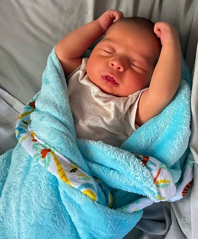 Declan is registered to the contest to win money with this photo: baby, baby_products, baby_sleeping, baby_toddler_clothing, cheek, child, comfort, electric_blue, face, head, iris, linens, pattern, person, sitting, skin, sleeve, toddler