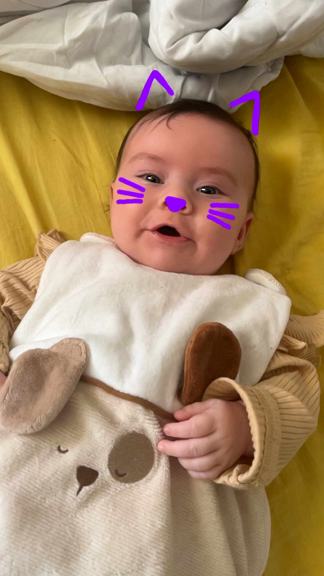 Angëlya participe au concours pour gagner de l'argent avec cette photo : baby, infant, child, smiling, face_paint, digital_overlay, purple, whiskers, cat_ears, blanket, yellow, clothing, cute, hand, bed, soft_toys, cozy, portrait, indoors, happy