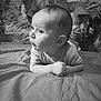baby, infant, child, black_and_white, bed, blanket, face, curious, portrait, indoors, wallpaper, pattern, hands, head, eyes, clothing, propped_up, young, cute, expression