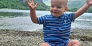 Matthew joined the competition — help win amazing prizes! toddler, child, lake, rocks, outdoor, nature, water, hill, cloudy_sky, blue_clothing, barefoot, smiling, grass, landscape, summer, scenic, recreation, playful, casual, happy