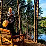 child, toddler, adult, bench, forest, trees, lake, outdoor, sunlight, nature, happy, playful, smiling, person, wood, sky, pine_tree, daytime, leisure, family