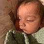 Gardenia is registered to the contest to win money with this photo: baby, sleeping, blanket, closeup, face, infant, child, peaceful, soft_lighting, indoors, cute, hair, bow, skin, portrait, rest, cozy, young, toddler, comfort