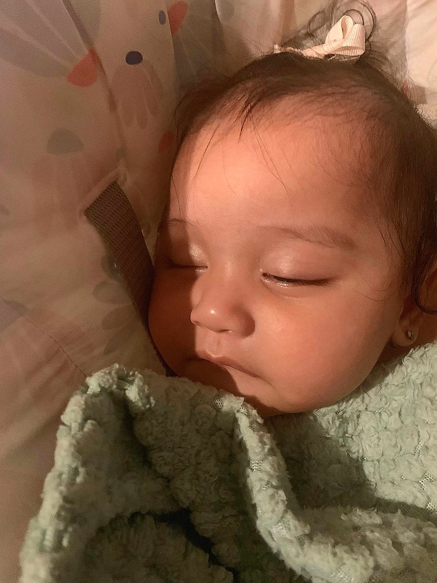 Gardenia is registered to the contest to win money with this photo: baby, sleeping, blanket, closeup, face, infant, child, peaceful, soft_lighting, indoors, cute, hair, bow, skin, portrait, rest, cozy, young, toddler, comfort