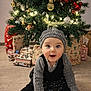 baby, child, christmas_tree, presents, holiday, festive, smiling, sitting, indoors, cute, hat, knitwear, floor, decoration, ornaments, lights, happy, celebration, seasonal, toddler