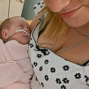 Delilah joined the competition — help win amazing prizes! baby, infant, woman, face, smile, blanket, hospital, nasal_tube, holding, close_up, portrait, love, care, person, clothing, necklace, pattern, indoor, skin, hair