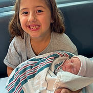 Charm joined the competition — help win amazing prizes! child, baby, newborn, smiling, hospital, blanket, striped_blanket, indoor, window, stroller, girl, happy, family, portrait, cute, holding, person, bed, clothing, headwear